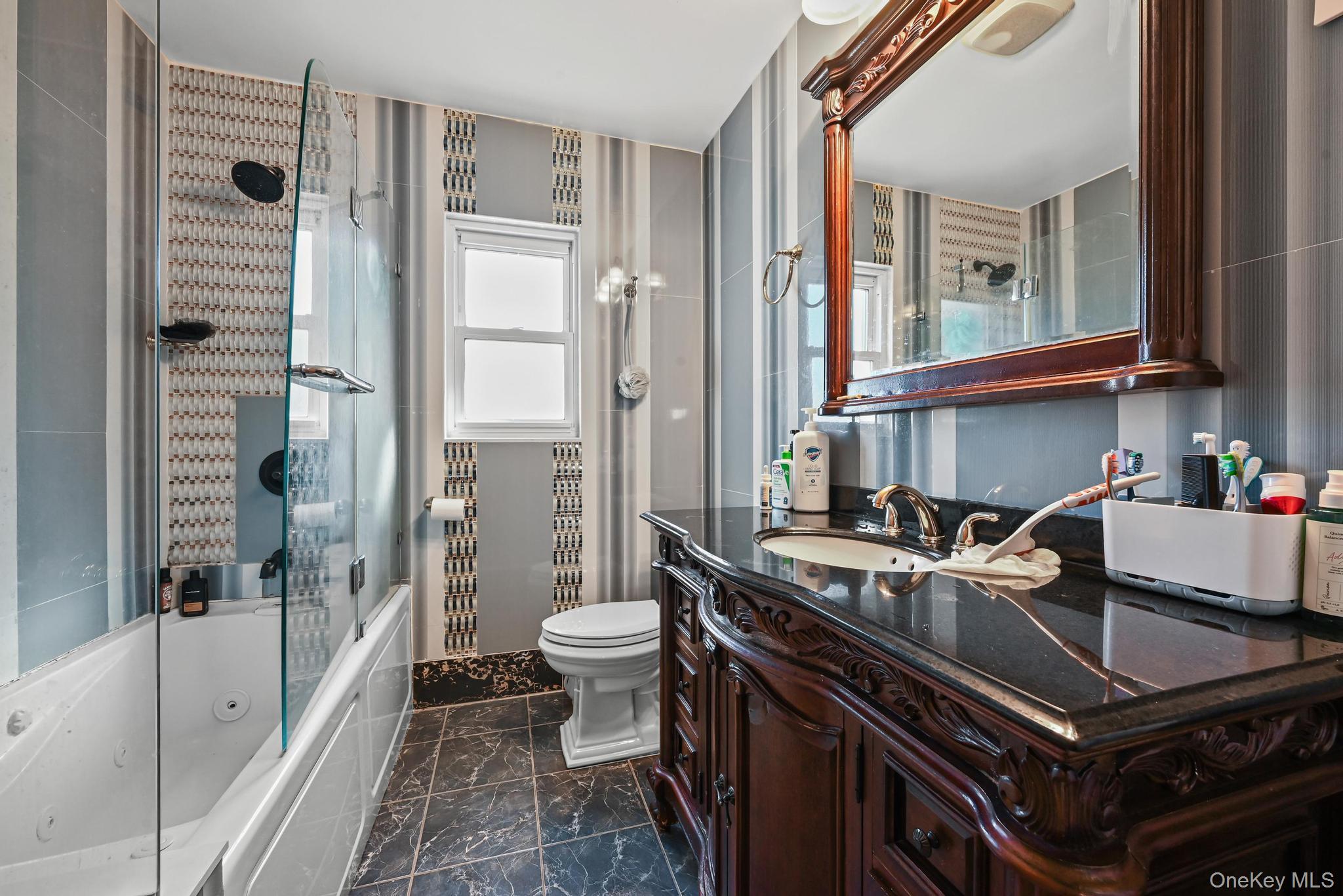 49 Ashley Drive Valley Stream, NY 11580 - Photo 23 of 29 a bath room with a sink a toilet and shower
