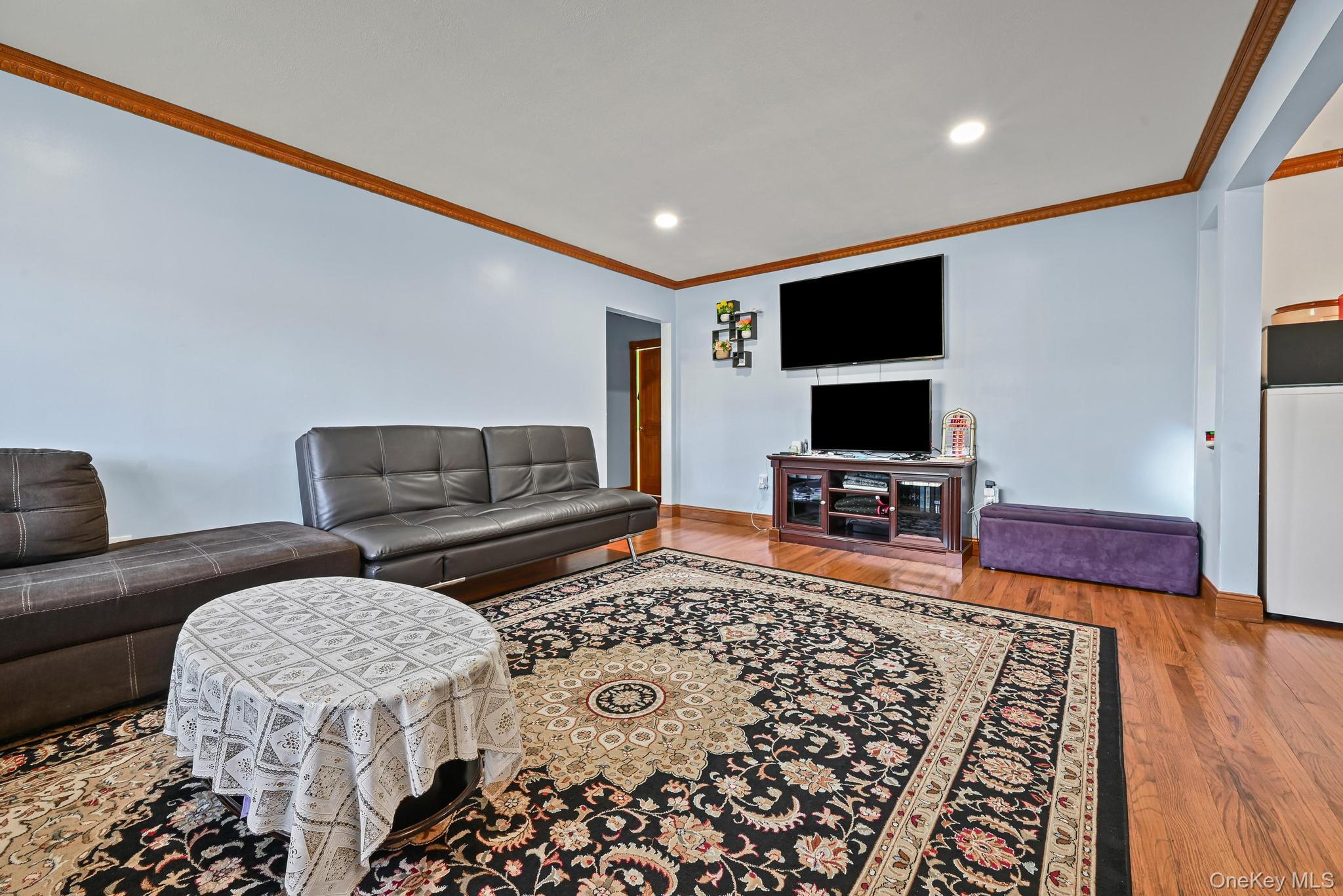 49 Ashley Drive Valley Stream, NY 11580 - Photo 25 of 29 a living room with furniture and a flat screen tv