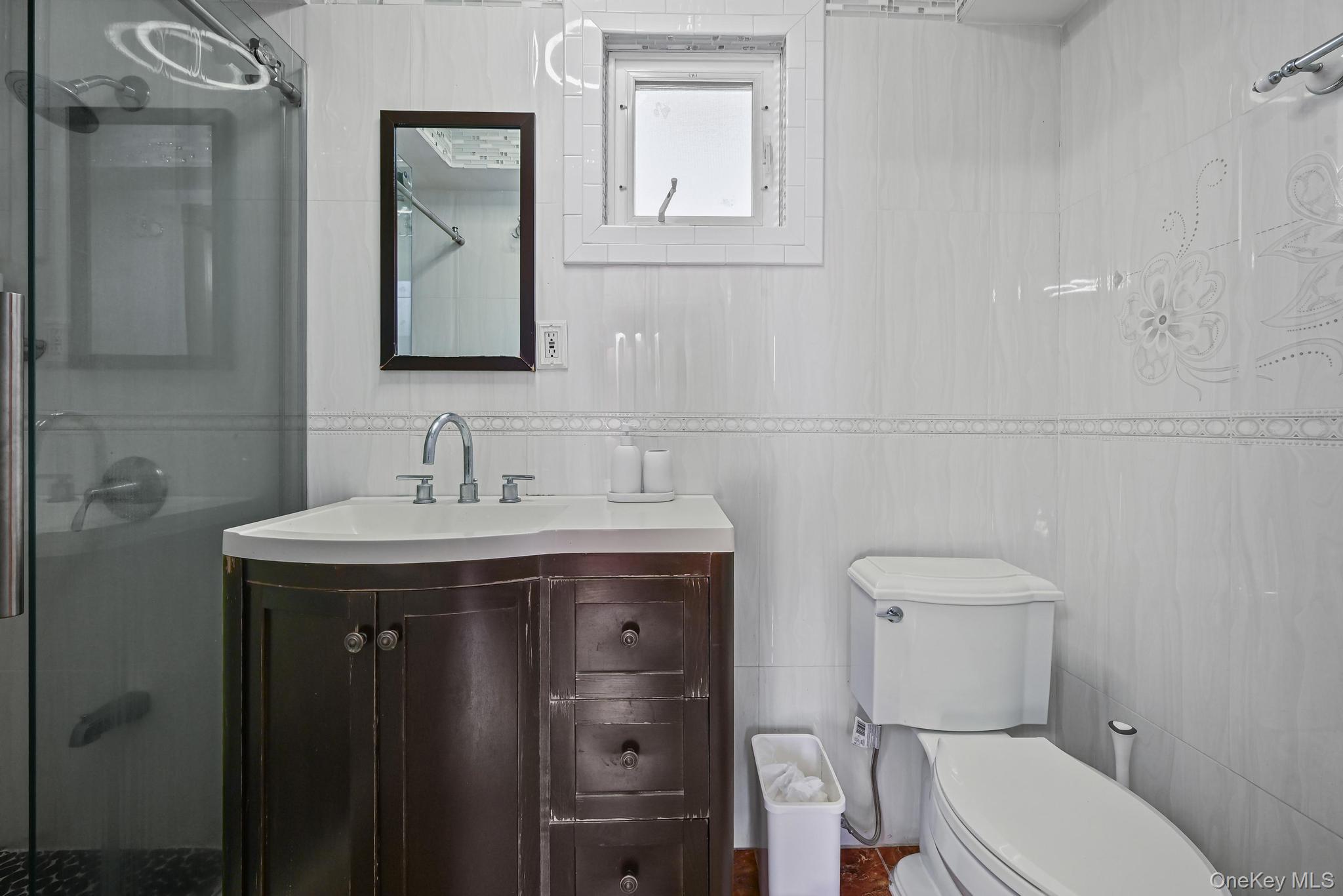 49 Ashley Drive Valley Stream, NY 11580 - Photo 26 of 29 a bathroom with a granite countertop toilet sink and mirror