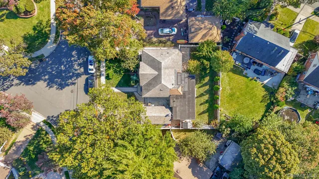an aerial view of a house with a yard and garden
