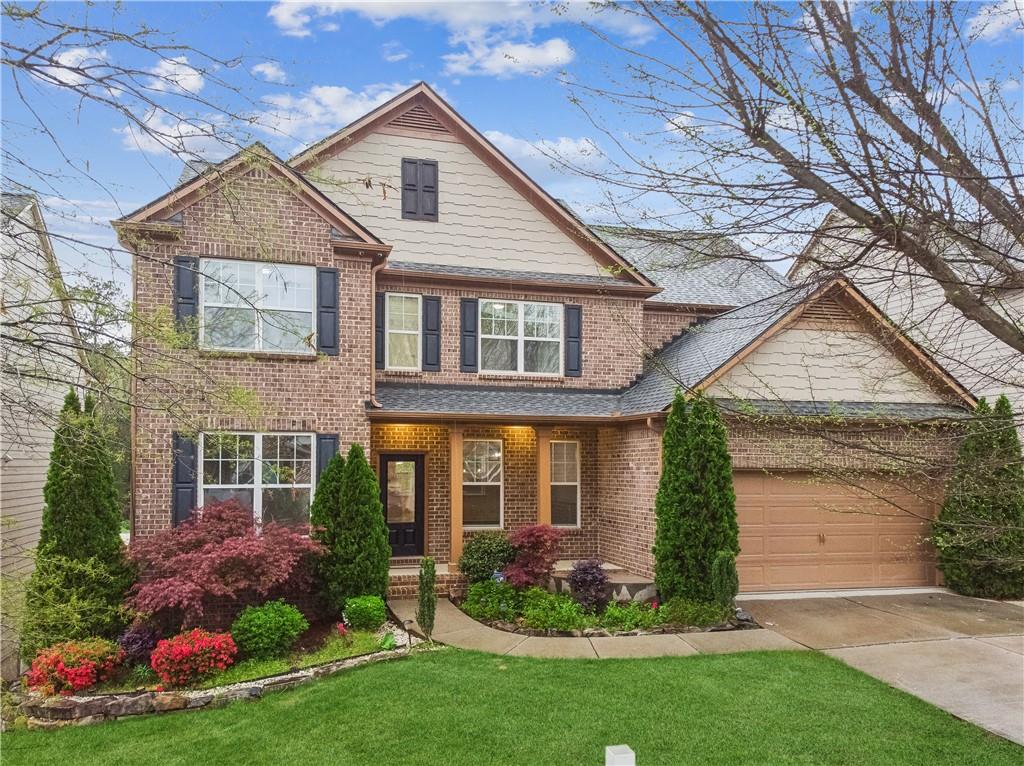 a front view of a house with a garden and plants
