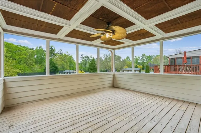 a balcony with wooden floor and city view