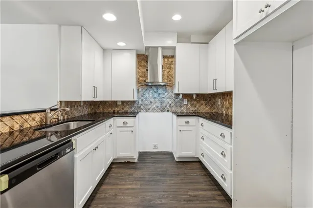a kitchen that has a sink and a stove in it