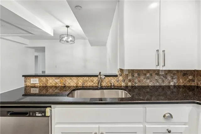 a kitchen with a sink and cabinets
