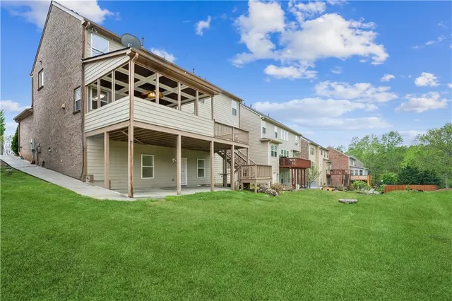 a view of a house with a yard and sitting area