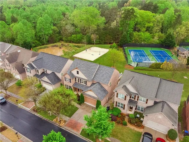 an aerial view of a house with a yard basket ball court and outdoor seating