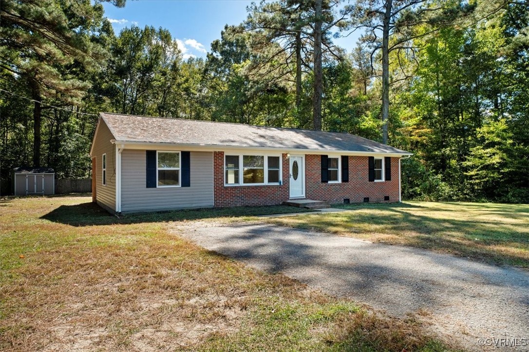 9217 South Quay Road Suffolk, VA 23437 - Photo 2 of 46 a view of a yard in front of a house with large trees