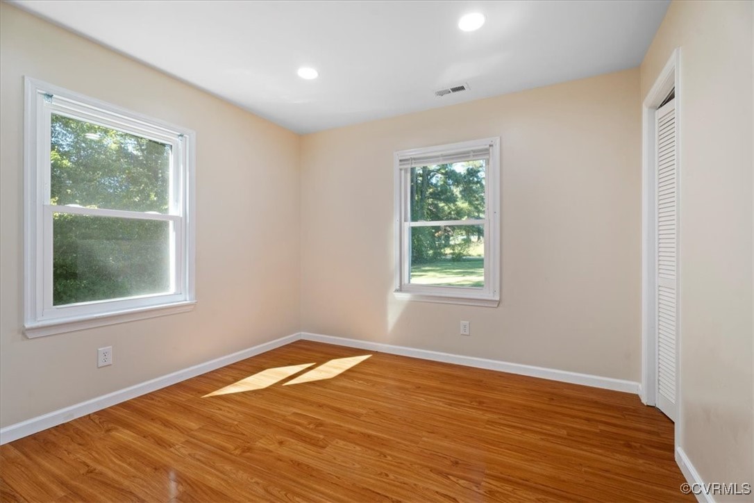 9217 South Quay Road Suffolk, VA 23437 - Photo 40 of 46 an empty room with wooden floor and windows