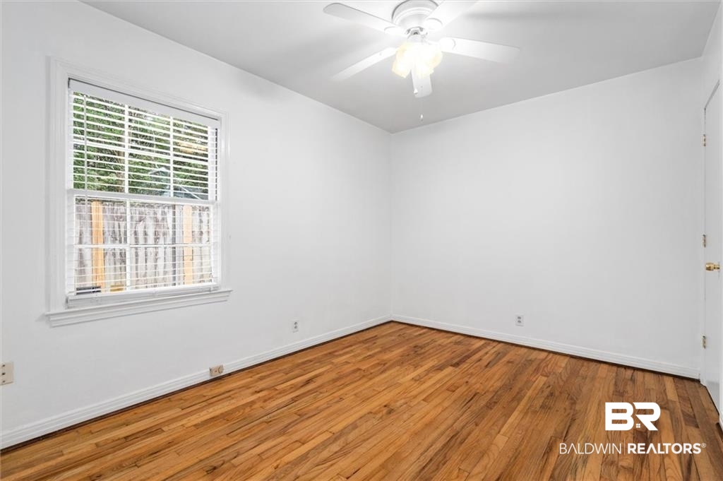 218 Grand Boulevard Mobile, AL 36607 - Photo 9 of 22 Empty room featuring ceiling fan and wood-type flooring