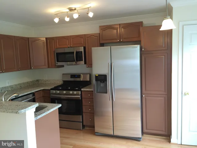a kitchen with a refrigerator stove and microwave