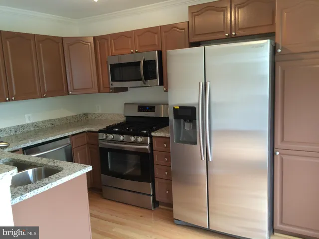 a kitchen with a refrigerator stove and microwave