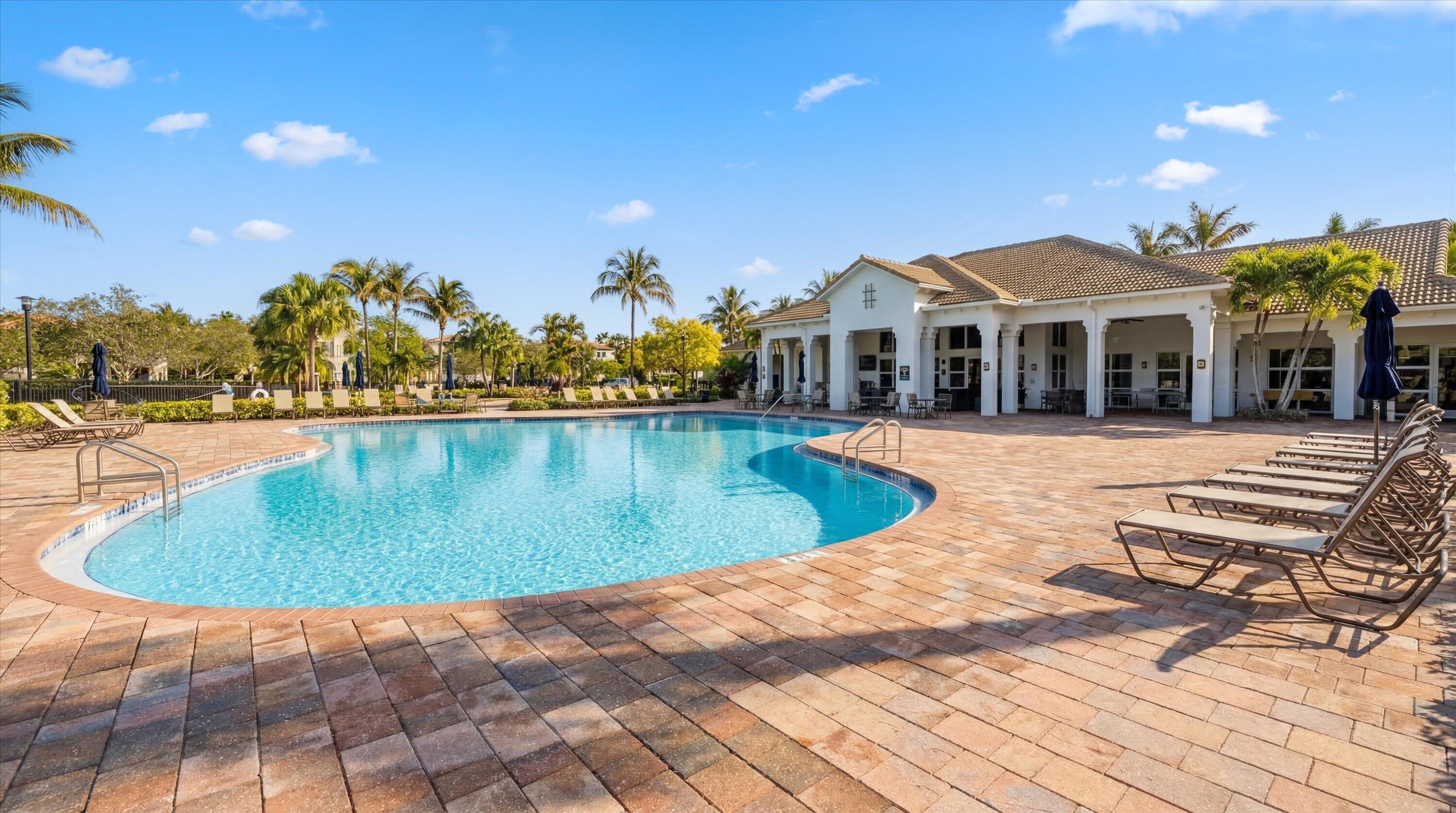 108 Casa Circle Jupiter, FL 33458 - Photo 47 of 53 a view of a swimming pool with a lounge chairs