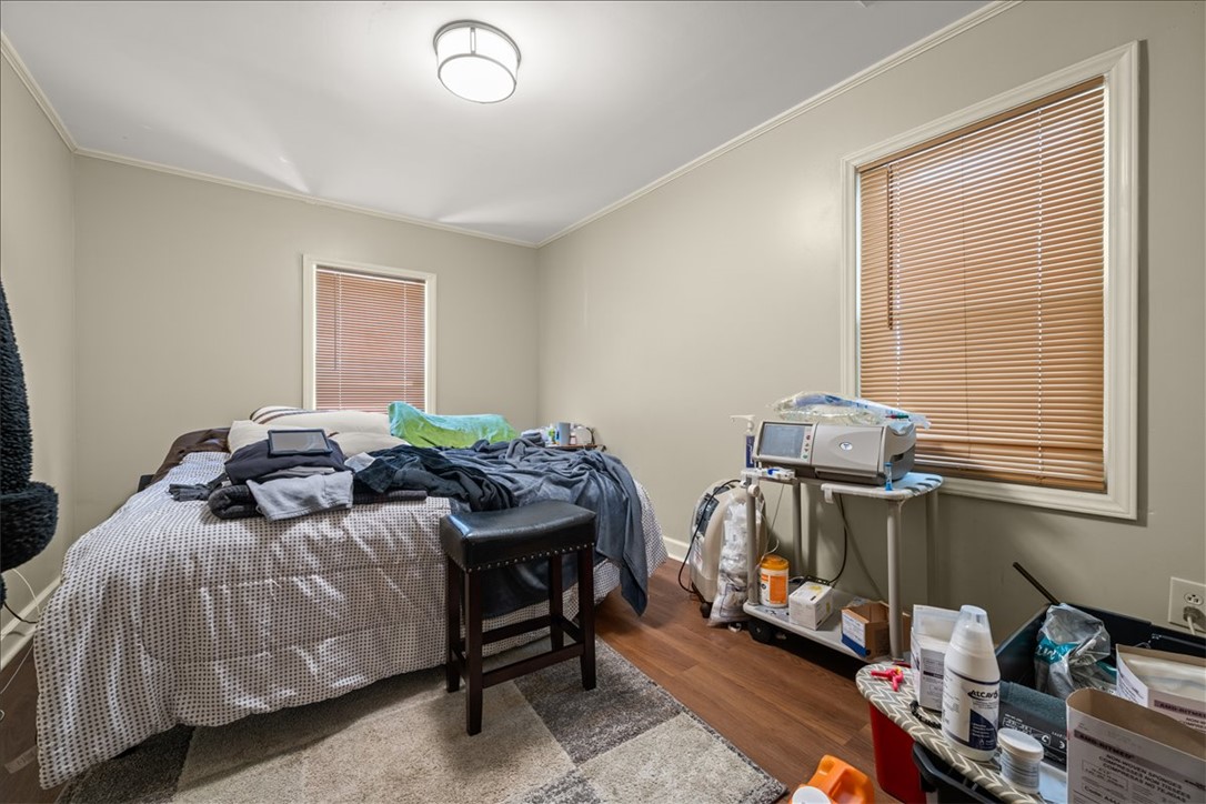 412 Sanders Street Anderson, SC 29624 - Photo 15 of 30 Hardwood floors and generous windows elevate this comfortable bedroom space.