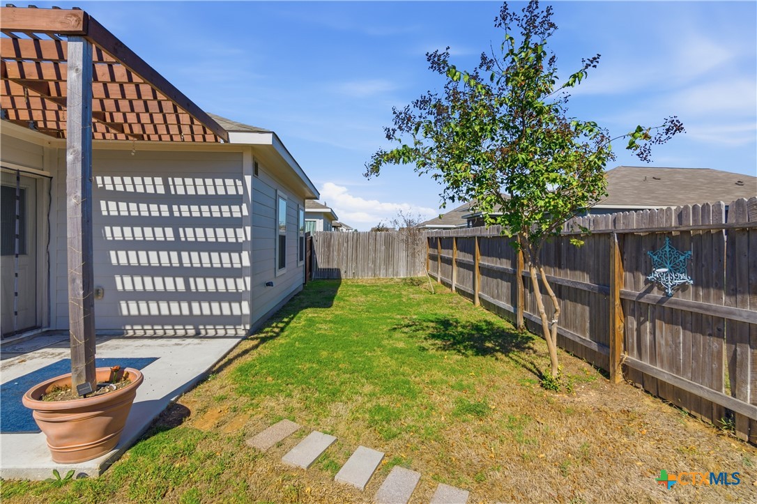 2437 Ranger Pass Seguin, TX 78155 - Photo 2 of 20 a view of a backyard with a small deck and a garden