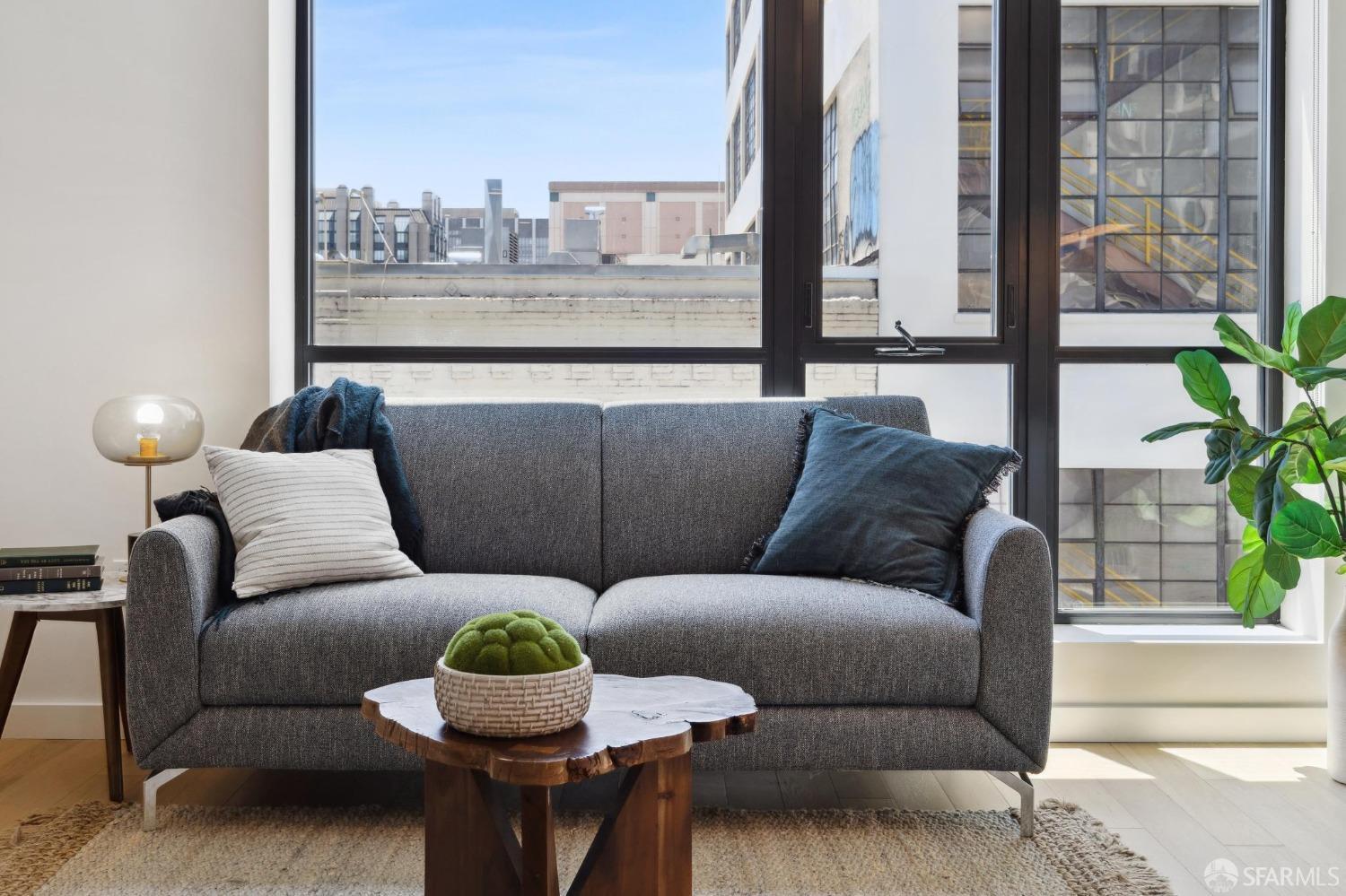 1201 Sutter Street, Unit 312 San Francisco, CA 94109 - Photo 1 of 10 a living room with furniture and a potted plant