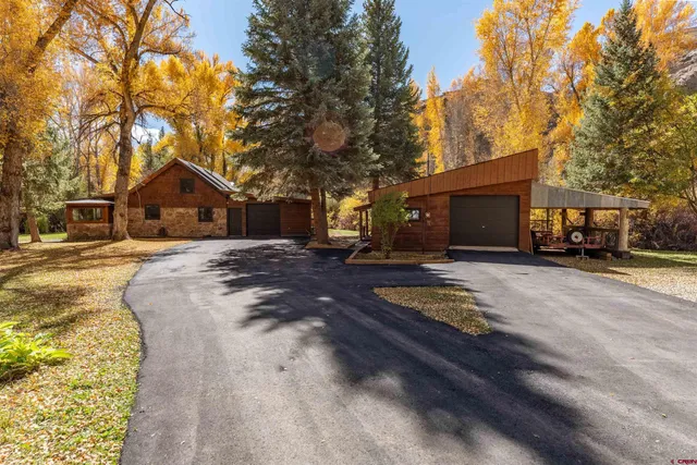 a front view of a house with a yard covered with snow