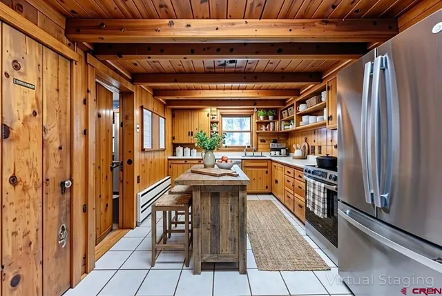 a kitchen with stainless steel appliances granite countertop a refrigerator and a stove