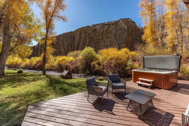 a backyard of a house with table and chairs