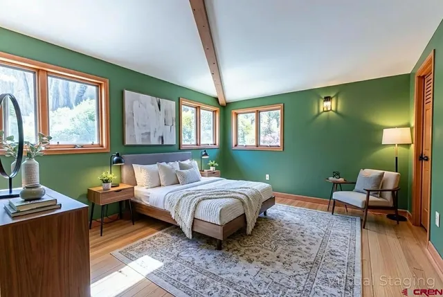 a living room with a bed furniture and a window