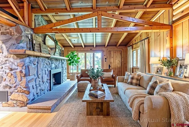 a living room with furniture a fireplace and a table