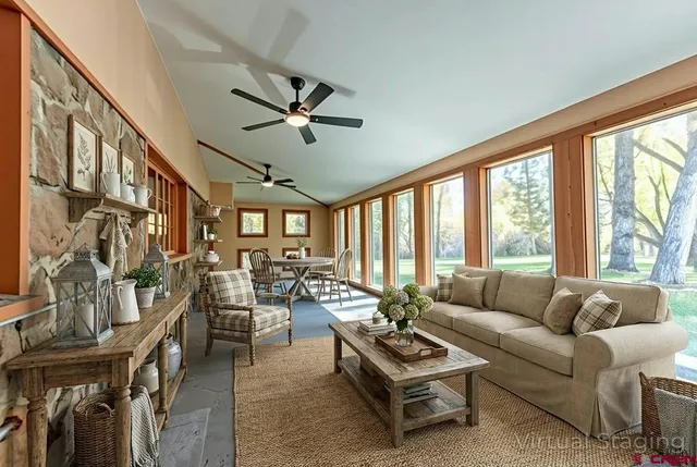 a living room with furniture and a large window