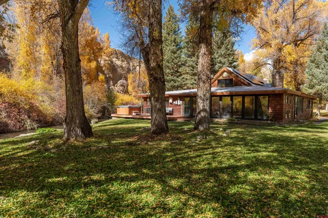 a front view of a house with a yard table and chairs