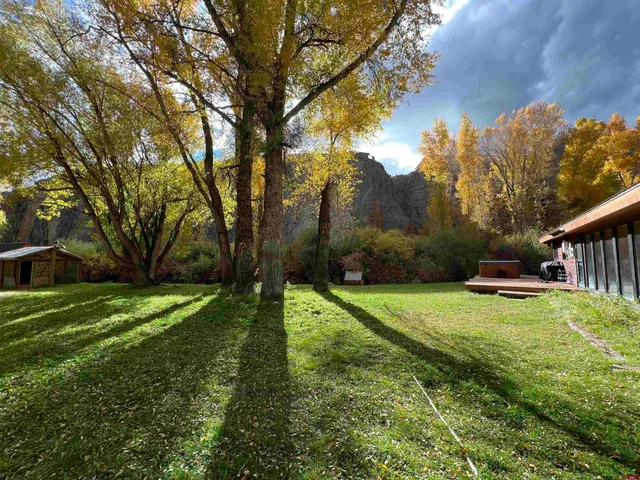 a backyard of a house with table and chairs