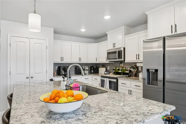a bedroom with furniture and a large window
