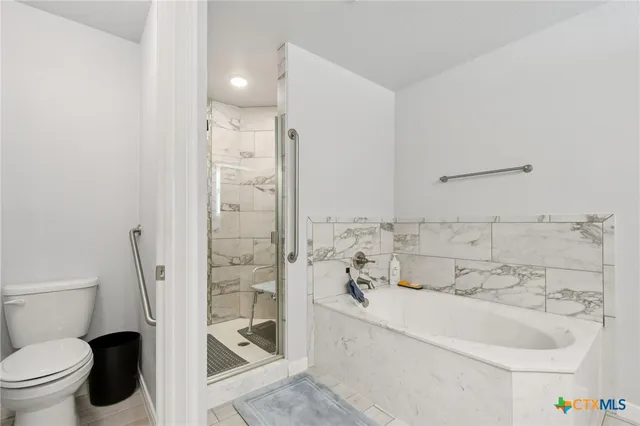 an empty room with wooden floor and ceiling fan