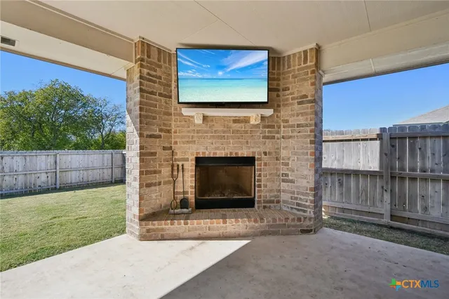 a view of living room with furniture and a fireplace