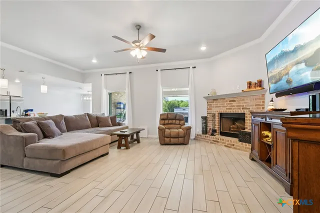 a living room with furniture fireplace and flat screen tv