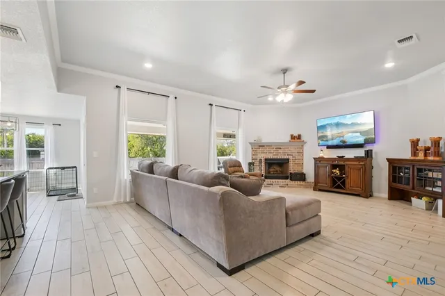 a view of empty room with wooden floor and window