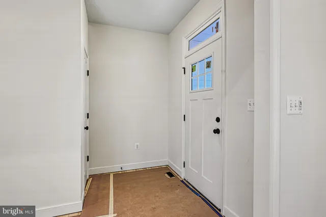 a view of a livingroom with wooden floor and a ceiling fan