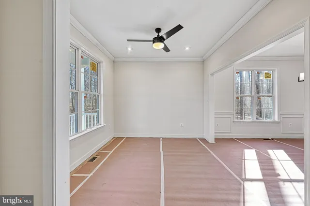 a view of a room with wooden floor and white walls