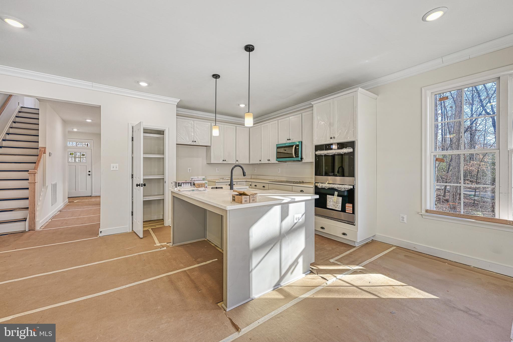 172 Covenant Way Bumpass, VA 23024 - Photo 24 of 56 a kitchen with stainless steel appliances kitchen island granite countertop a stove a sink and a refrigerator