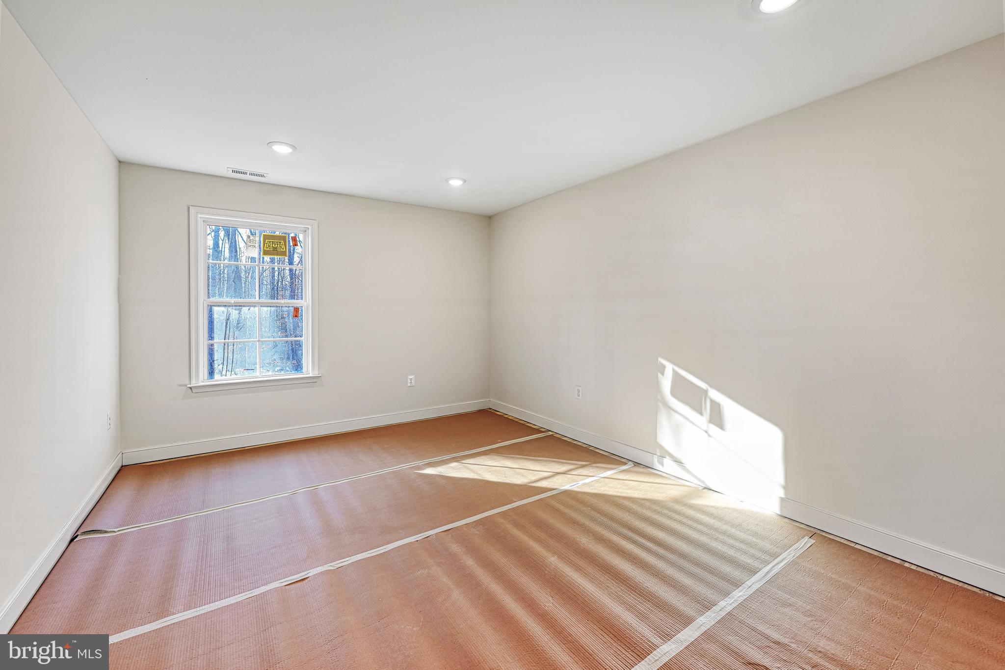 172 Covenant Way Bumpass, VA 23024 - Photo 47 of 56 a view of an empty room with wooden floor and a window