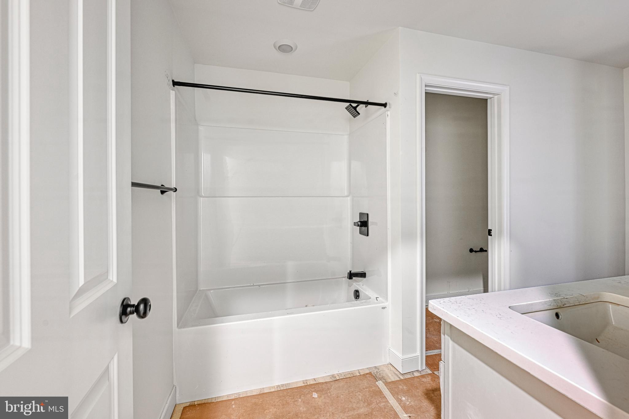 172 Covenant Way Bumpass, VA 23024 - Photo 51 of 56 a bathroom with a tub a sink and a shower