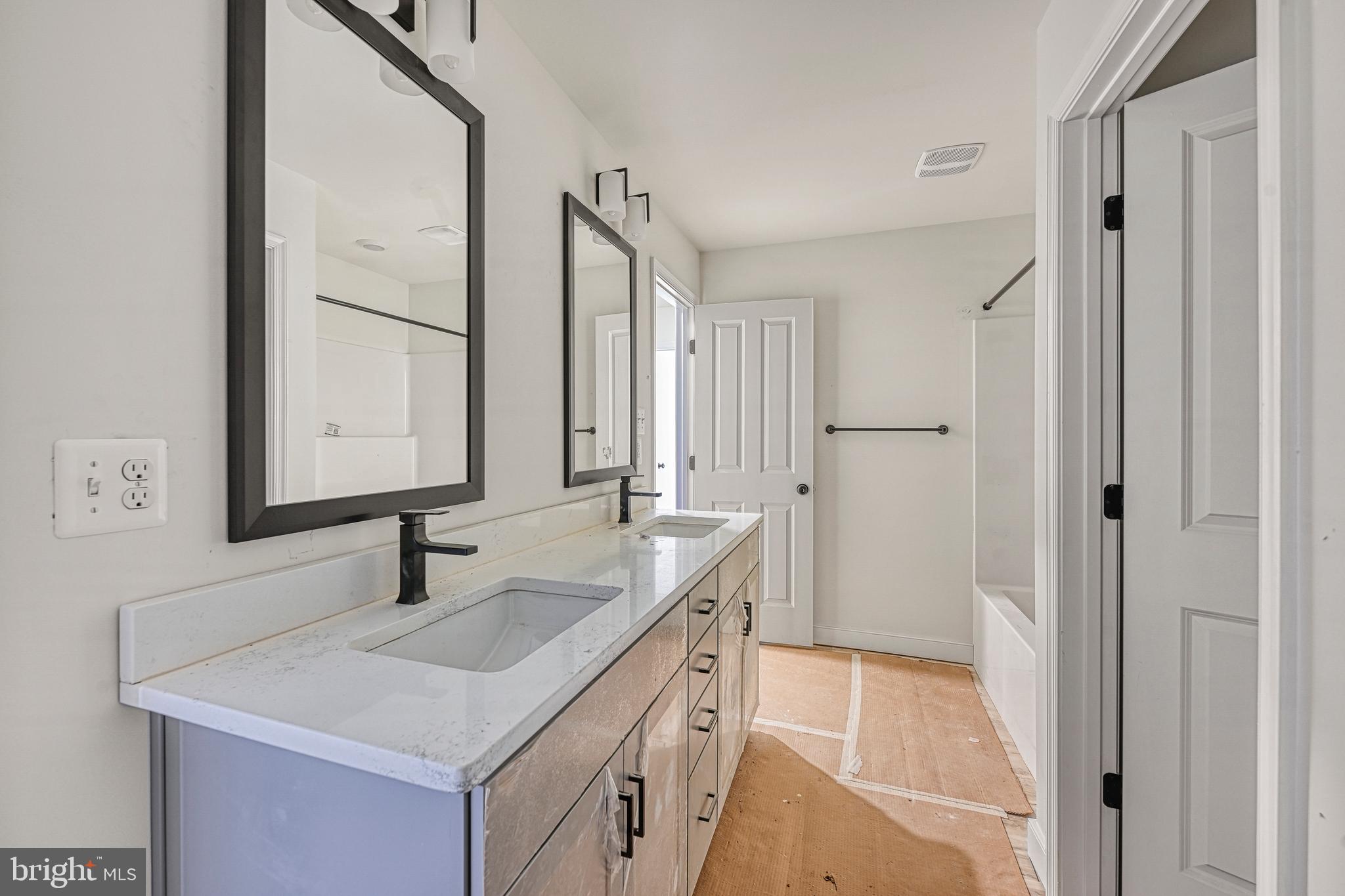 172 Covenant Way Bumpass, VA 23024 - Photo 52 of 56 a bathroom with a sink and a mirror