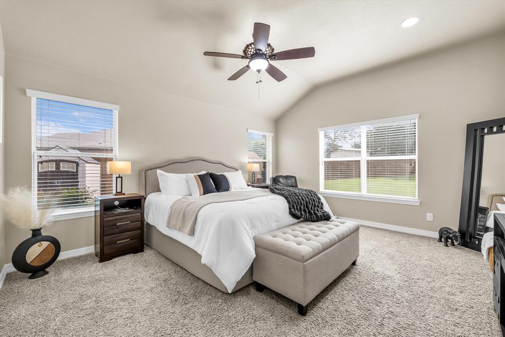 910 Springdale Lane Lorena, TX 76655 - Photo 17 of 39 Carpeted room featuring a vaulted ceiling with a ceiling fan, multiple windows with blinds, and recessed lighting