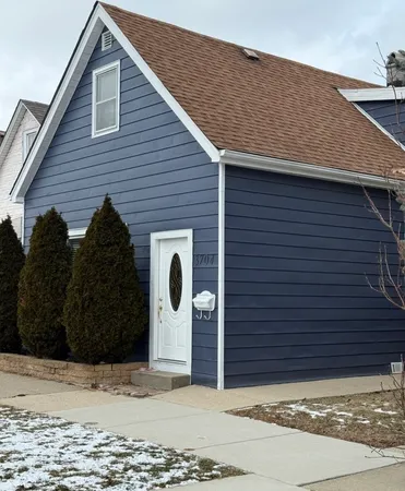 a view of a house with a wooden fence