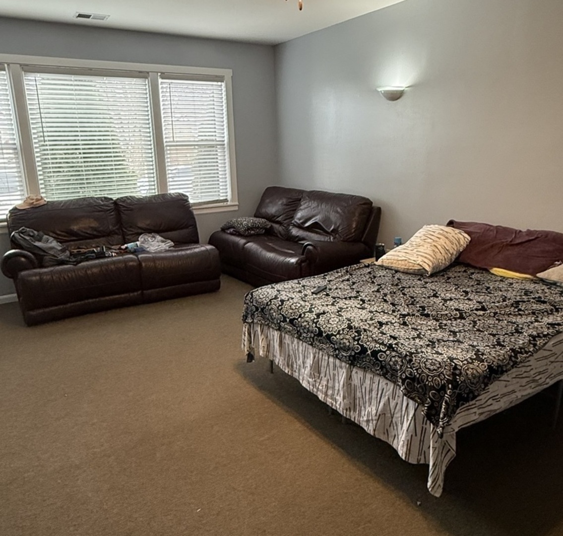 3704 West 58th Street Chicago, IL 60629 - Photo 4 of 12 a bedroom with two bed and a couch