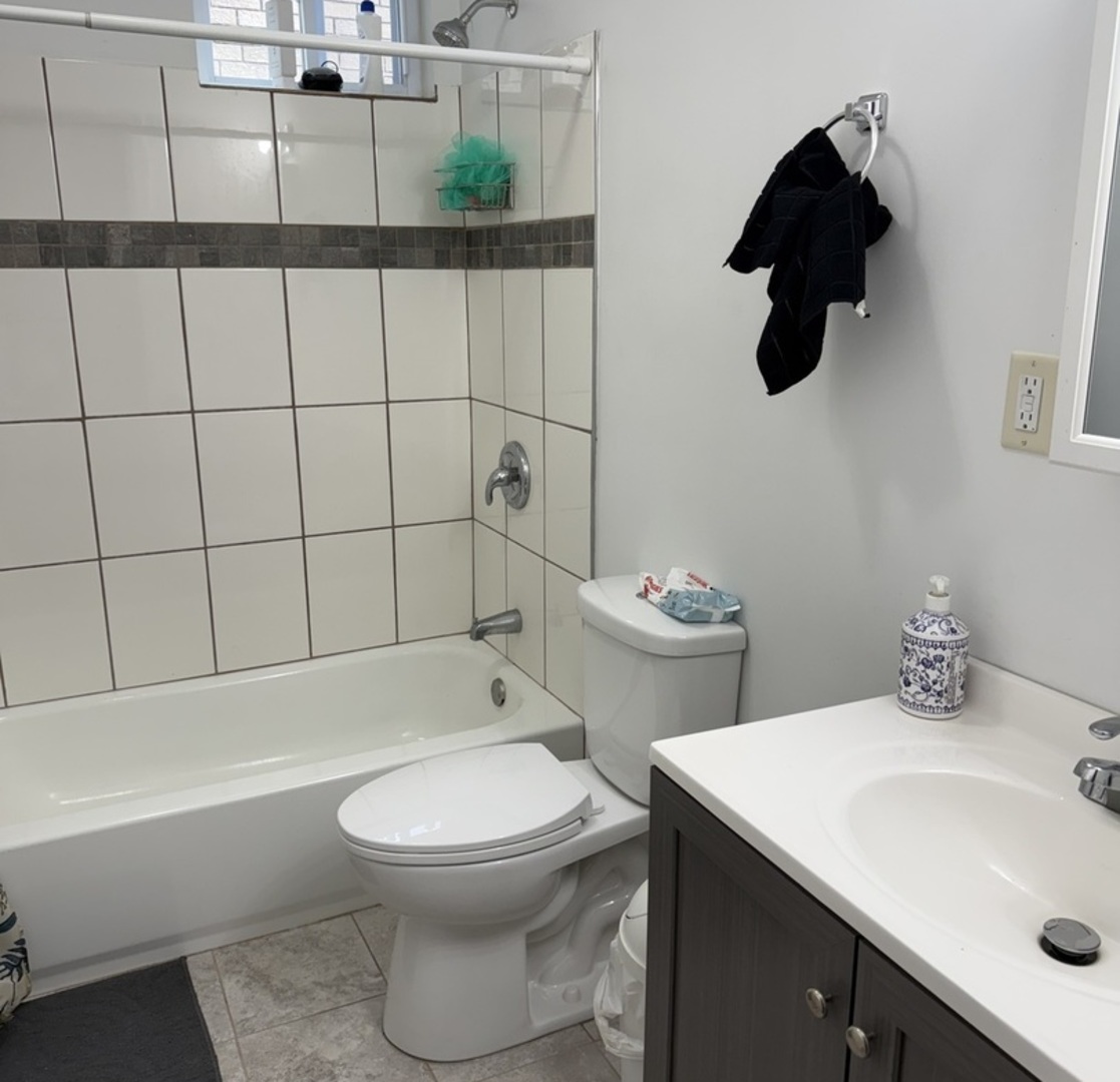 3704 West 58th Street Chicago, IL 60629 - Photo 6 of 12 a bathroom with a sink toilet and shower