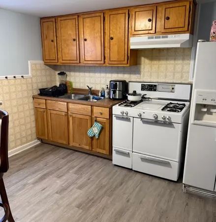 a kitchen with wooden cabinets and a stove top oven