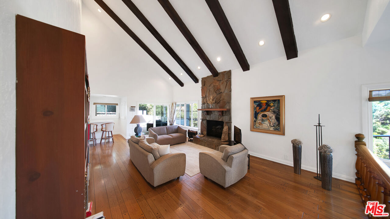 2312 Kimridge Road Beverly Hills, CA 90210 - Photo 11 of 60 a living room with fireplace furniture and a wooden floor