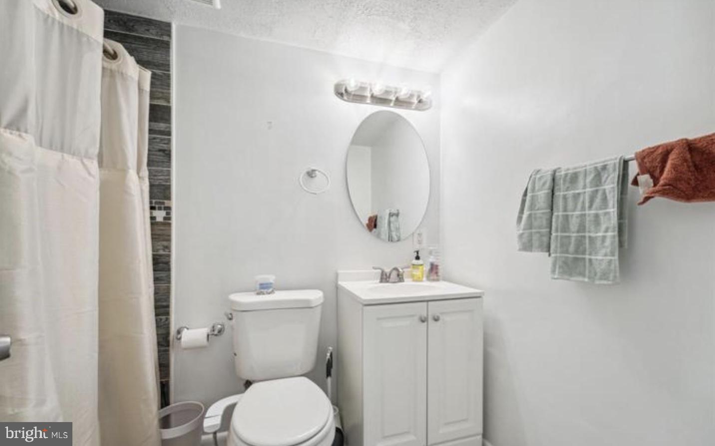 3841 St Barnabas Road, Unit T1 Suitland, MD 20746 - Photo 2 of 14 a bathroom with a toilet a sink and mirror