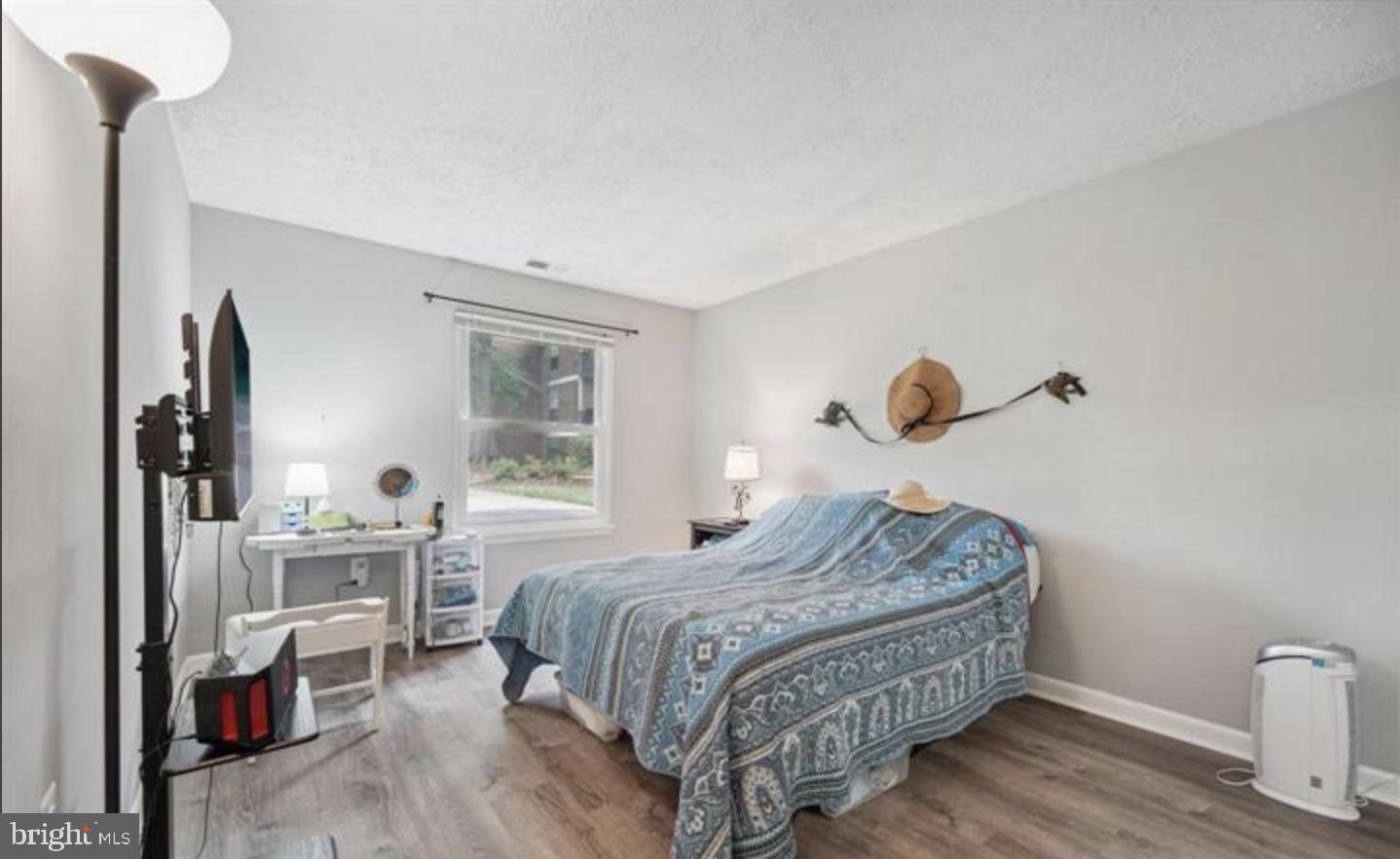 3841 St Barnabas Road, Unit T1 Suitland, MD 20746 - Photo 5 of 14 a bedroom with a bed and a table in it