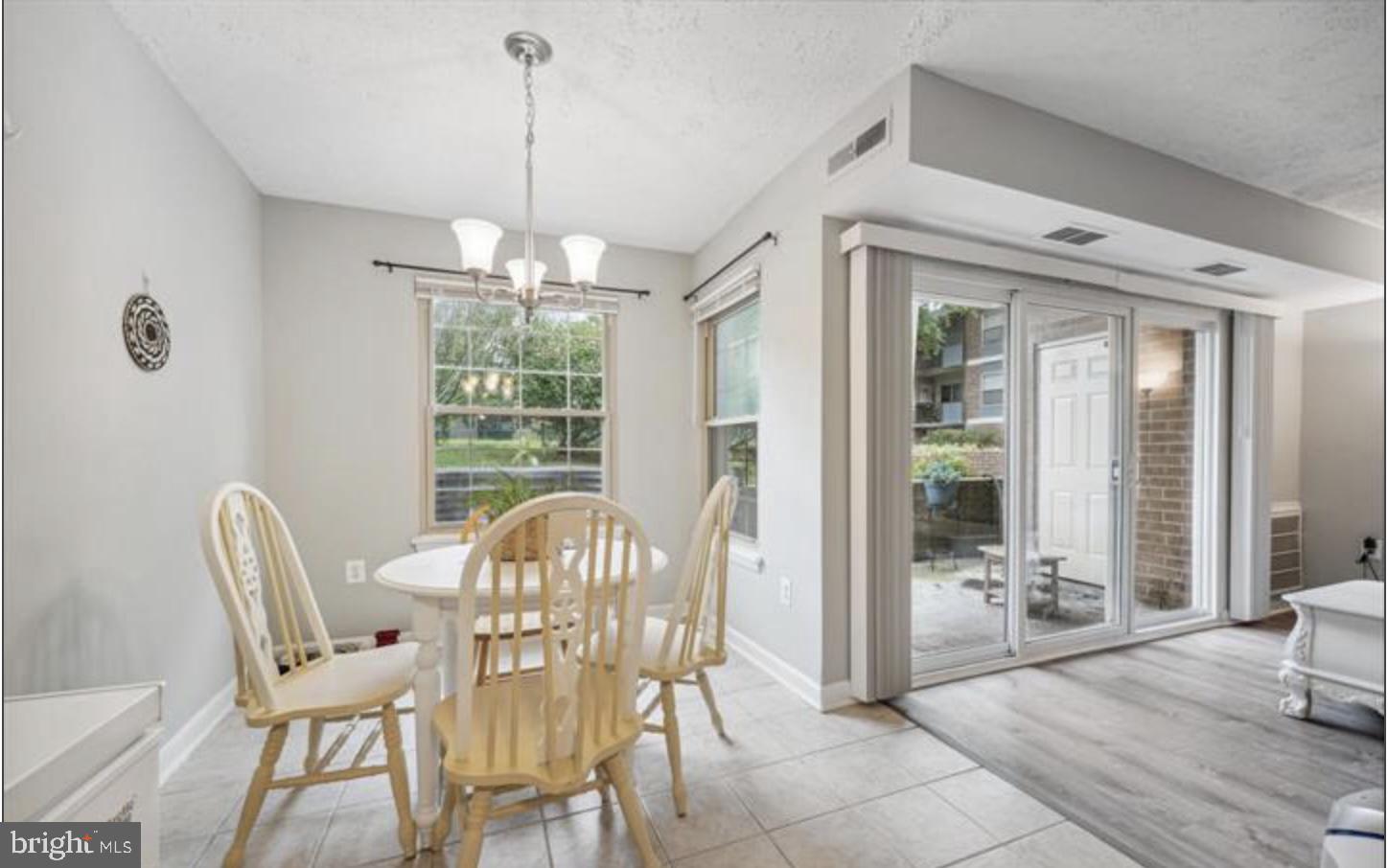 3841 St Barnabas Road, Unit T1 Suitland, MD 20746 - Photo 6 of 14 a view of a dining room with furniture window and outside view