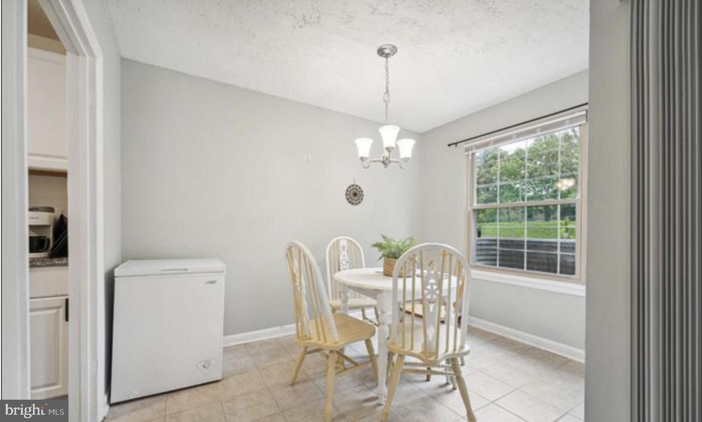 3841 St Barnabas Road, Unit T1 Suitland, MD 20746 - Photo 7 of 14 a view of a dining room with furniture window and outside view