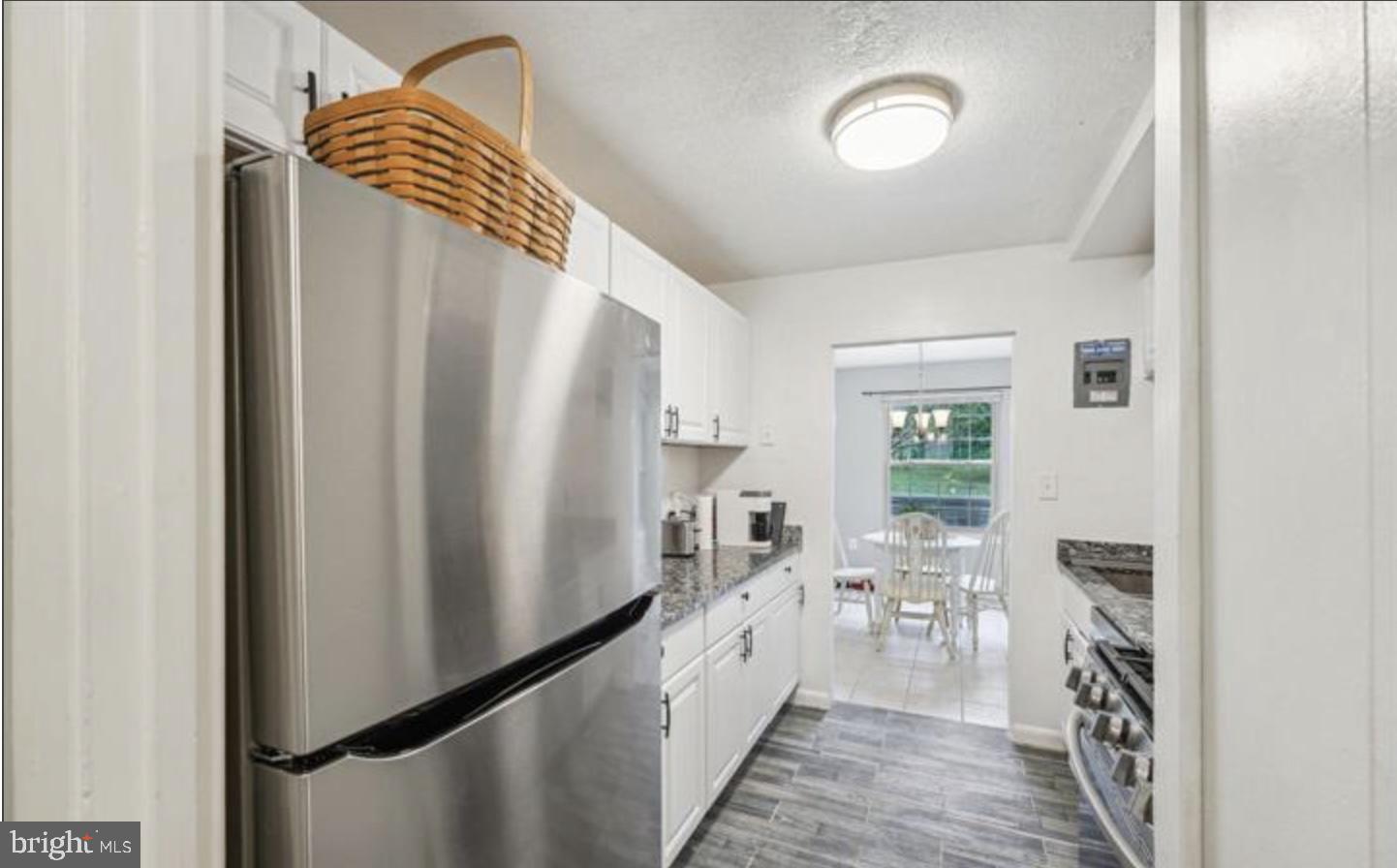 3841 St Barnabas Road, Unit T1 Suitland, MD 20746 - Photo 9 of 14 a kitchen with stainless steel appliances a refrigerator and a wooden floor