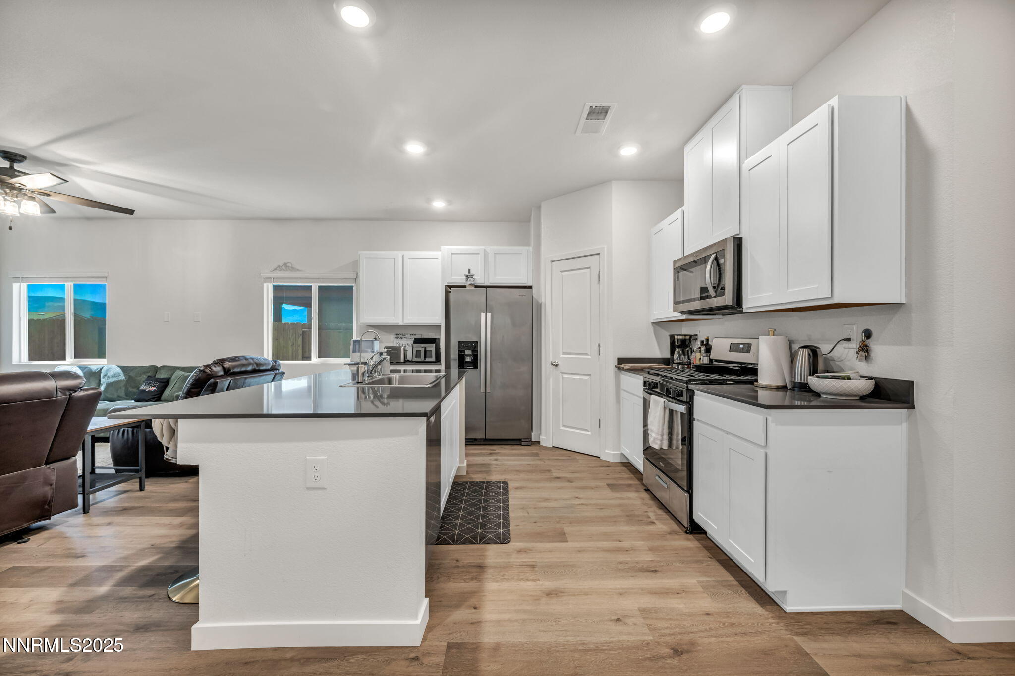 1019 Anthony Court Fernley, NV 89408 - Photo 29 of 55 a kitchen with kitchen island granite countertop a stove top oven a sink a counter top space and cabinets